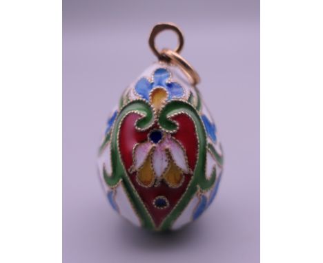 A Russian silver enamel egg pendant. 3 cm high.