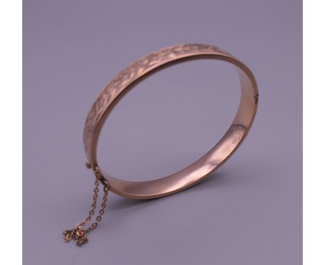 A 9 ct gold bangle bracelet. 6 cm wide. 10.8 grammes.