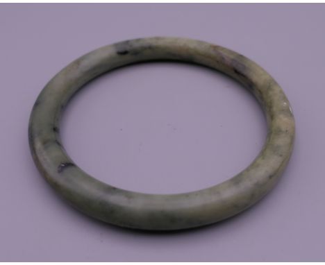 A jade bangle. 6 cm interior diameter.
