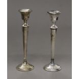 A pair of silver candlesticks. 20.5 cm high. 371.3 grammes loaded.