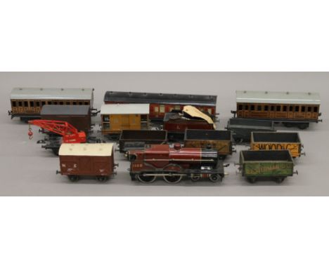 A large quantity of Hornby and Bassett Lowke O-Gauge train set and accessories, including a locomotive, carriages, an engine 