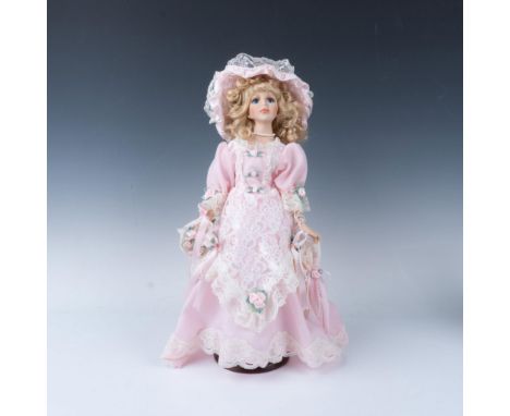 Gorgeous large figure of a woman draped in an intricate pink dress detailed with lace trimmings and flowers. Metal stand with