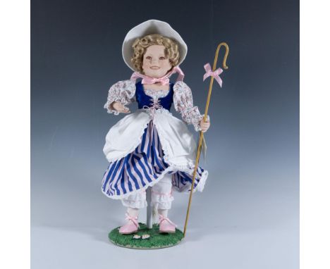 Embossed Shirley Temple signature on this rendition of her, dressed in striped and floral country girl attire. Carrying her s