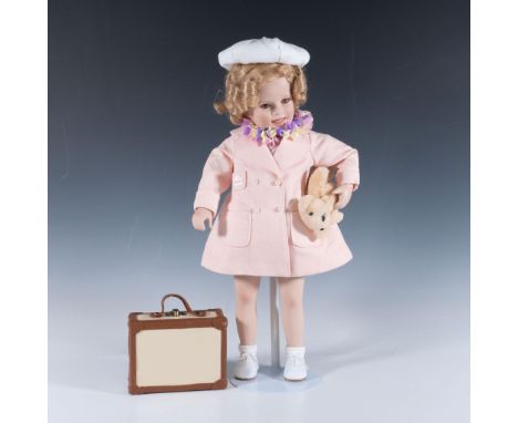This piece features porcelain, hand-painted face and head, dressed in a beautifully crafted tourist outfit. Doll measures 8.5