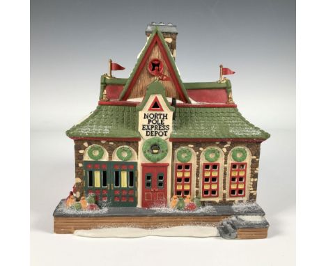 Hand painted porcelain building titled North Pole Express Depot from the Heritage Village Collection. It features a snow dust