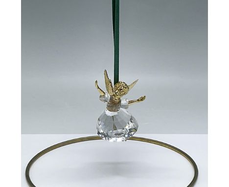 This retired piece was the first in a limited edition series. The angel has gold plated metal head, wings and arms with a len