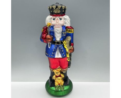 A large figure of a nutcracker drummer boy with glitter detailing. Dimensions: 5"L x 4.25"W x 13"HManufacturer: Roman Inc. Co