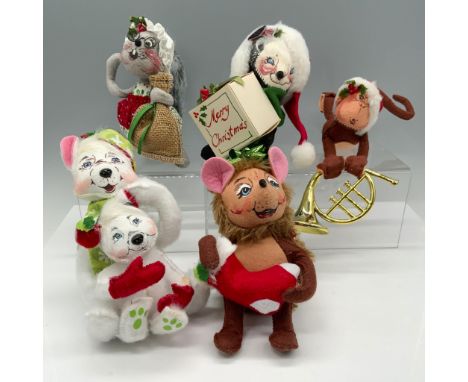 Darling collection of festive critters that consists of a polar bear with their cub, a hedgehog with a holiday stocking, a mo