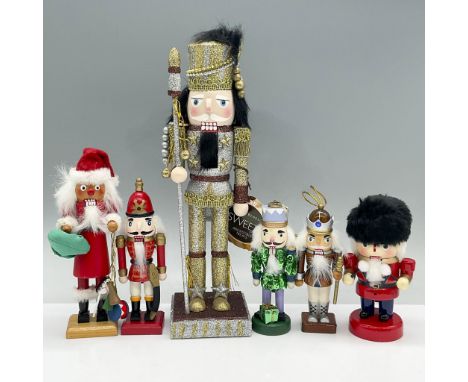 Features one large glittery nutcracker with a Henry Bendel tag, three smaller nutcrackers and two small nutcracker ornaments.