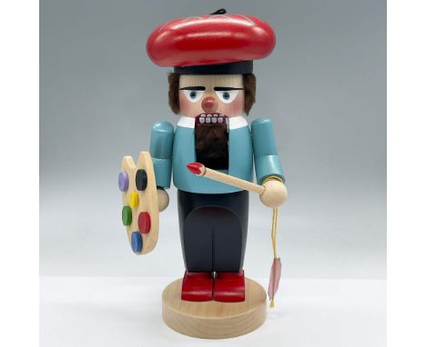 This is a handmade Nutcracker holding a paintbrush and painting palette. Tag reads Steinbach. Carved Steinbach to the undersi