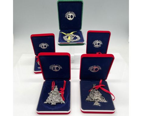 Individually engraved metal ornaments include Dancing Bear, Rocking Horse, Animal Kingdom, Bunny and Lion. Presented in velve