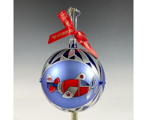 Handcrafted glass bauble displays a vibrant and nostalgic design, featuring charming toy motifs, as a detailed red airplane, 