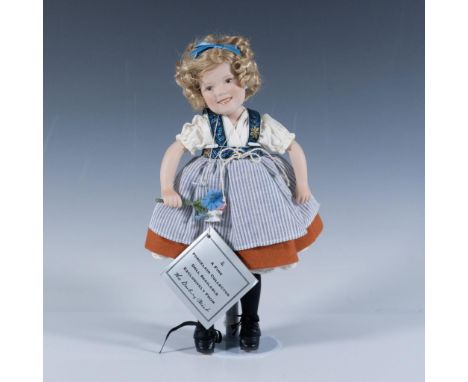 Captured in her most famous movie role this doll is hand painted and styled as she appeared in the role. Metal stand accompan