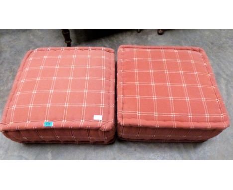 A pair of pink pouffe cusions
