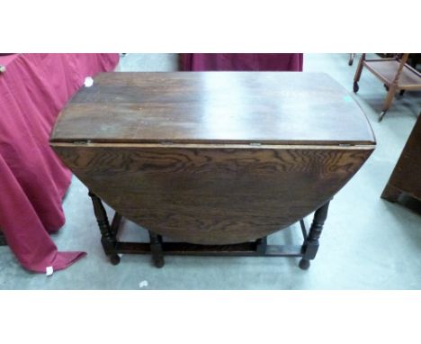 A 1920's oak gateleg table. 42'' wide( A.F), together with a lamp standard