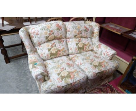 A cottage style sofa in floral loose covers