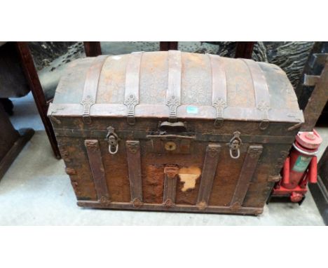 A Victorian dome top trunk with wood strapping containing two vintage push-along toys and a dressmaker's dummy. 36'' wide