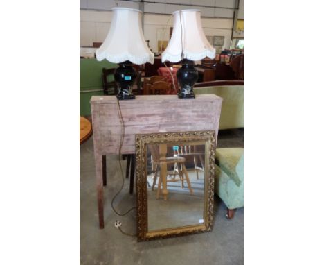 A pair of ceramic based table lamps and a wall mirror