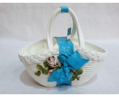 A late 19th century ceramic basket with blue bow and applied with roses. 10½'' high. Cracked