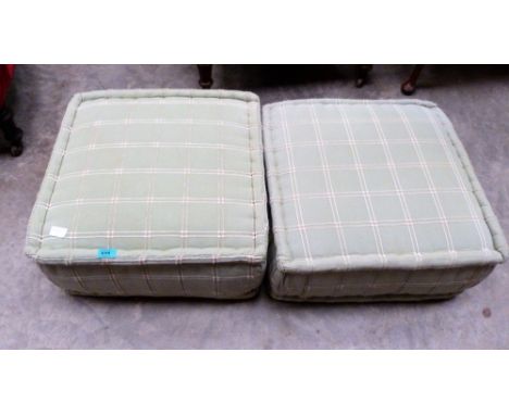 A pair of green pouffe cushions