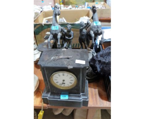 A French black slate mantle clock 11'' high; a pair of garnitures (one A.F) and a pair of speltar horse and figure groups