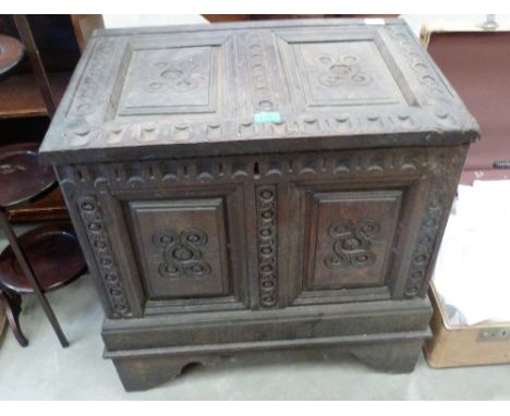An antique joined oak two panel chest with geometric and notch carving, on bracket feet. Elements 17th century. 25½'' wide