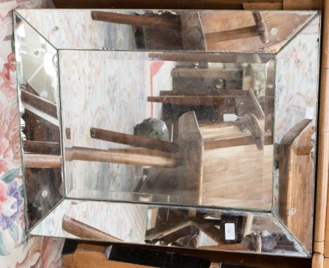 A rectangular mirror, segmented to form a mirrored frame, 57cm by 72cm