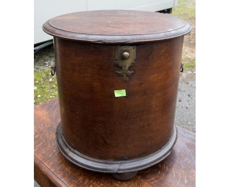 A mid 18th Century oak commode, of barrel form, raised on bun feet