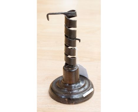 An early 19th Century adjustable iron candlestick, on patinated beech sockle, 10cm deep by 19cm high