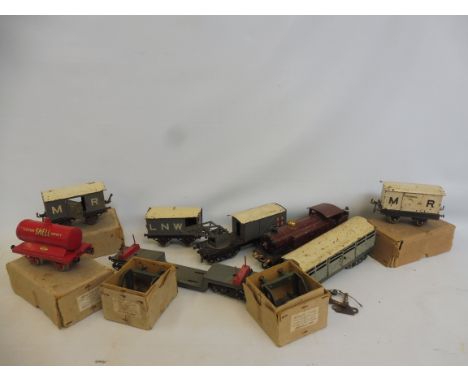 A quantity of very early Hornby O gauge clockwork including a large scale LMS engine, a refrigerator van, rolling stock. 