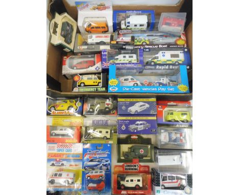A collection of approximately 25 boxed assorted scale die-cast ambulance and emergency vehicle models to include Corgi, Soled