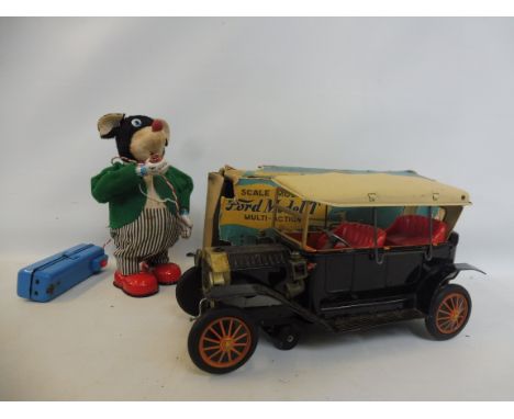 Two battery operated models, a scale model of a Ford Model T and an animal smoking a pipe.