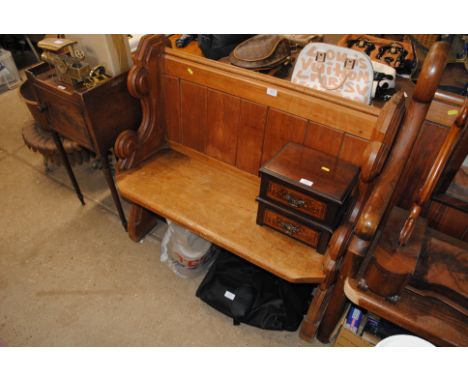 A pine pew of small proportions 