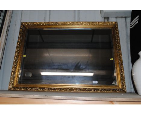 A gilt framed bevel edged oblong wall mirror 