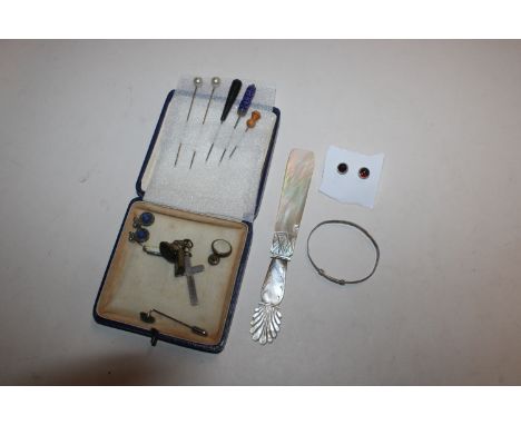 A box containing stick pins, earring, a child's silver bangle, silver crucifix, miniature penknife etc. 