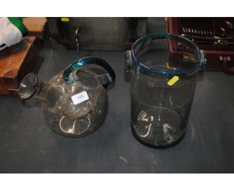 A tinted bubble glass wine carafe with blue glass handle and a similar ice bucket 