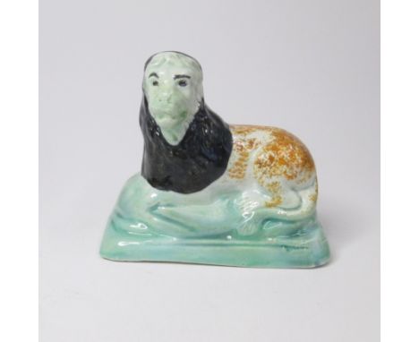 A Small Staffordshire Prattware model of a lion recumbent on an oblong baseCirca; 1800Size; width 9cm, height 7.5cmCondition: