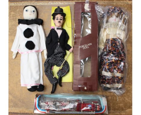  Toys: A collection of three assorted figures, included boxed porcelain doll, unboxed Pierrot doll, and unboxed Laurel puppet
