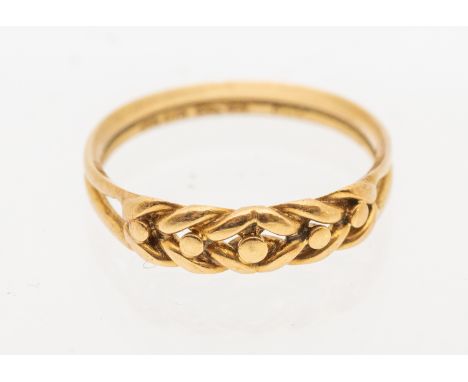 An 18ct gold knot ring, width approx 4mm, size N, weight approx 2.6gms  Further details: wear to sides commensurate with age 