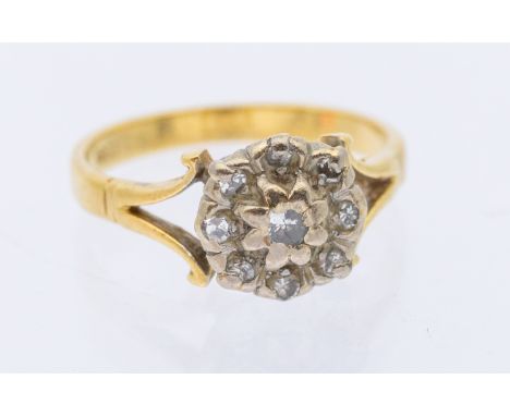 A diamond and 18ct gold cluster ring, comprising a round cluster set with small diamonds, scrolled shoulders, size N, total g
