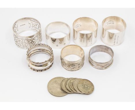 A collection of  five early 20th Century silver napkin rings, various designs, dates and makers, approx. 4.67 ozt (145.4g) to