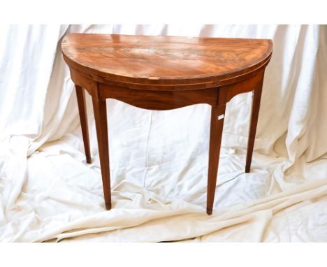 A George III half round mahogany card table.