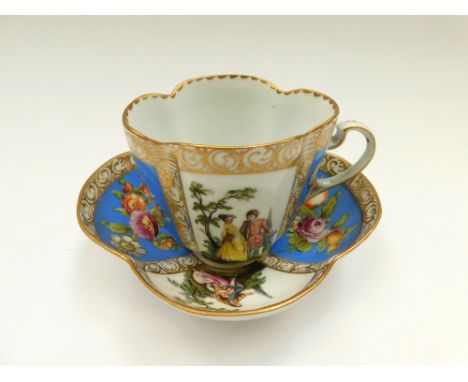 A Dresden quatrefoil cup and saucer with two blue panels painted with floral sprays and two panels painted with classical Wat