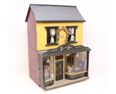 Dolls House: A mid-20th century kit-built two-storey dolls house, the lower floor comprising a boutique with contents. Lighti