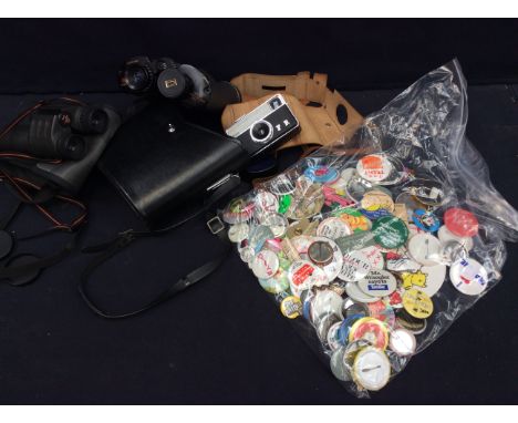 Two pairs of binoculars, vintage camera and a collection of vintage pin badges.