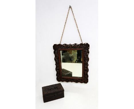 A Chinese early 20th Century carved hardwood mirror along with an Indian carved hardwood trinket box.
