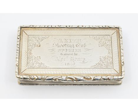 An early Victorian silver presentation snuff box, reeded sides with cast ornate border, the cover with engraved border and pr