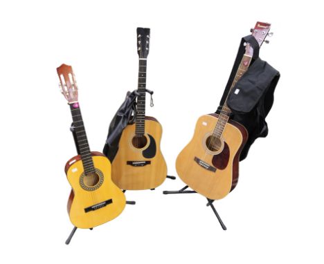  A Burswood acoustic guitar, Hohner and Herold guitars, all on stands, two with carry cases.