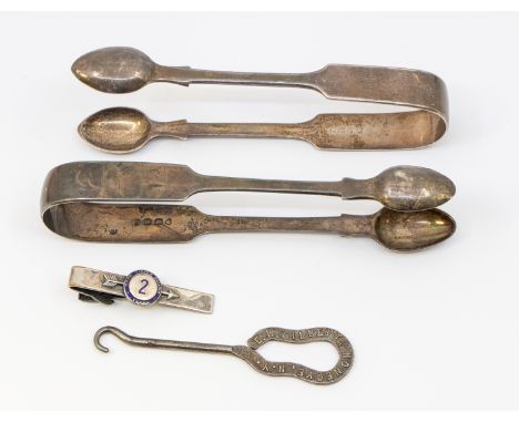 A pair of Victorian silver sugar tongs, hallmarked by HJ Lias & Sons, London, 1877, a similar pair of William IV silver sugar