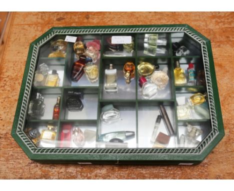 A collection of thirty-four miniature and sample perfume bottles, comprising vintage and later examples, Chopard, Moschino, G